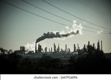 Smoke Stack Rising From Huge Oil Refinery Showing The Causes And Pollution Of Climate Change In Action In Corpus Christi , Texas , USA