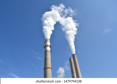 Smoke Stacks Against Blue Sky