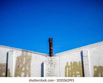 Smoke Stacks And Blue Skies In A Warehouse District