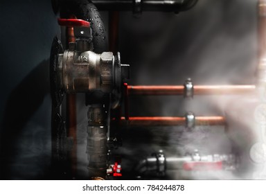 Smoke And Steam In A Boiler Room. Copper Pipes And Valves On A Wet Boiler