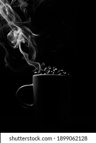 Smoke Steaming From Coffee Mug Full Of Coffee Beans On Black Background