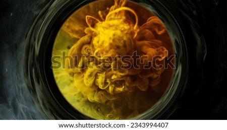 Smoke vortex. Ink water splash. Dimension portal. Yellow orange green color vapor cloud in round frame swirl on dark abstract background with free space.