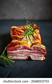 Smoked bacon with fresh rosemary. Close-up