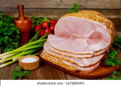 Smoked Boneless Ham With Vegetables And Salt On Wooden Christmas Table.