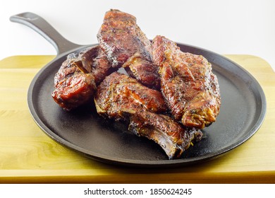 Smoked Country Style Pork Ribs Served On A Seasoned Cast Iron Skillet. Selective Focus, Background Blur And Foreground Blur 
