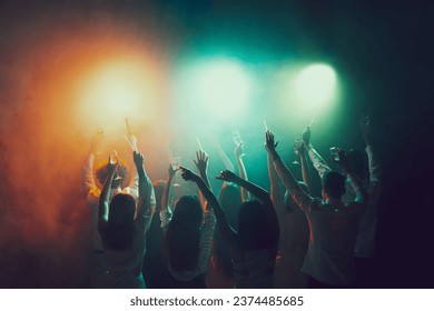 Smoked effects. Night lifestyle. Vising concert. Group of young, active people at the night club, party dancing in neon lights. Concept of party, fun, holiday, relaxation, meeting Copy space for ad