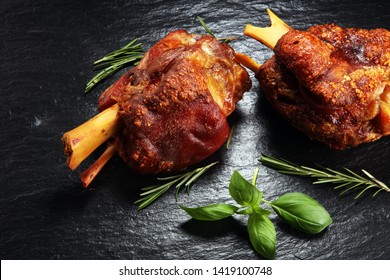 Smoked ham hock with herbs and spices. Roasted pork knuckle. Ham and bacon are popular foods in the west. German Schweinshaxe or Haxe - Shutterstock ID 1419100748