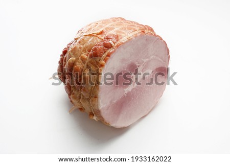 Smoked ham isolated on a white background. Homemade, smoked cold cuts, in netting, cut, with visible cross section. Traditional meat product, a packshot photo for package design, template.
