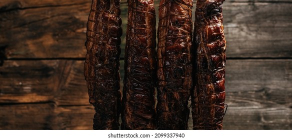 Smoked Ham In Smokehouse. Hanging Ham In The Smokehouse Smoked Bacon For Smoking. Banner, Menu, Recipe Place For Text.