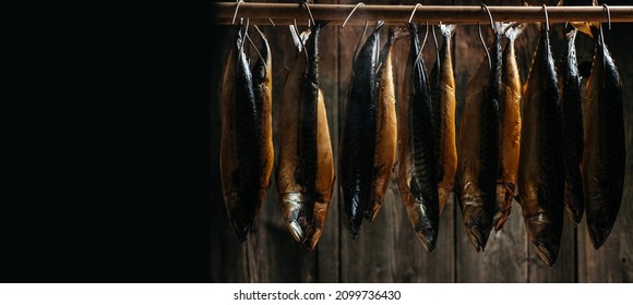 smoked mackerel. Smoking Process Fish. Smoking fish hanging side by side in a smoker. Long banner format.