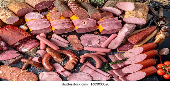 Smoked meat products. Display meats, cold cuts and sausages in a butcher's shop. Delicatessen Concept panoramic photo.