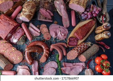 Smoked meat products. Display meats, cold cuts and sausages in a butcher's shop. Assortment of cold meats, variety of processed cold meat products.