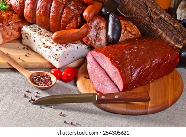 Smoked Meat And Sausages On A Kichen Table