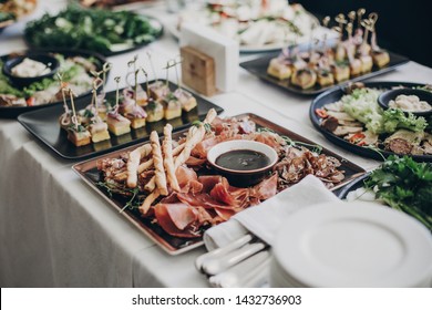 Smoked Meat,sauce,prosciutto, Salad Appetizers On Table At Wedding Or Christmas Feast. Luxury Catering Concept. Delicious Italian Food Table At Wedding Reception.