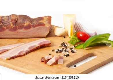 Smoked Pork Bacon Slab On Cutting Board With Vegetables