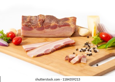 Smoked Pork Bacon Slab On Cutting Board With Vegetables