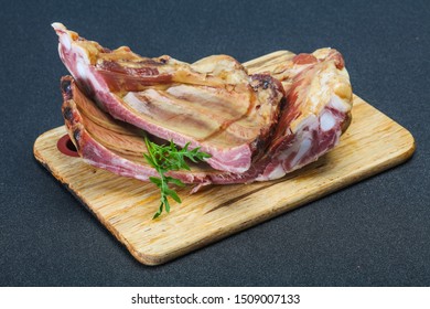 Smoked pork ribs over the wooden background served rucola - Shutterstock ID 1509007133