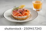 Smoked Salmon Bagel: Toasted bagel topped with smoked salmon, cream cheese, capers, and red onions. A classic and elegant breakfast option.