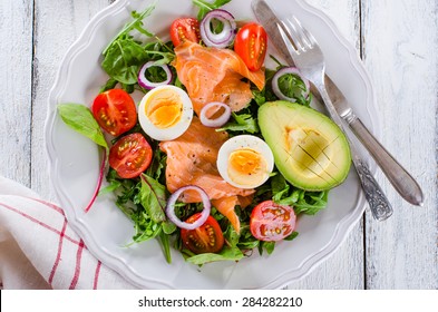 Smoked salmon salad with greens, tomatoes, eggs and avocado