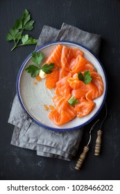 Smoked Salmon Slices With Salted Salmon Caviar Decorated With Fresh Parsley Leaves. Overhead View