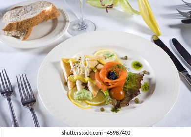 Smoked salmon with toast appetizer on white plate