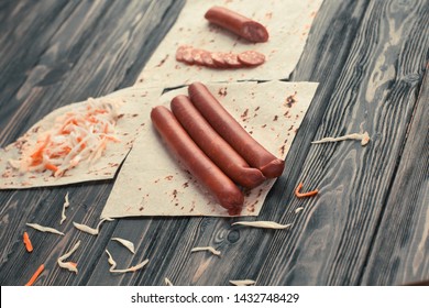 Smoked Sausages And Cabbage For Making Burrito Isolated On Wooden Background