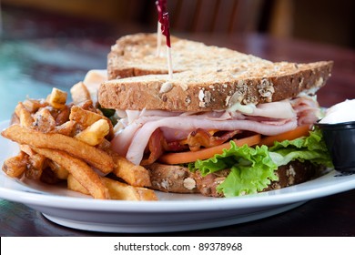 Smoked turkey, smoked ham, smoked bacon, swiss cheese, cheddar cheese, lettuce, tomato, onion, mayo served on a toasted multigrain bread. - Powered by Shutterstock