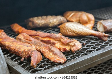 Smoked Turkey Legs And Chicken Wings Closeup Outdoors In Smokehouse, Street Food