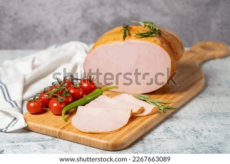 Smoked turkey meat sliced. Smoked turkey-ham fillets on a wood serving board. Deli products. Сток-фото © 