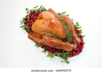 Smoked Turkey On A Tray Garnished With Fresh Cranberries And Herbs Over White Background. Thanksgiving Or Christmas Theme. (studio Isolated, Not PS)