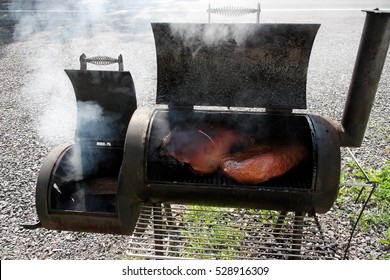 Smoker Grill Smoking Ham And Brisket. Horizontal.