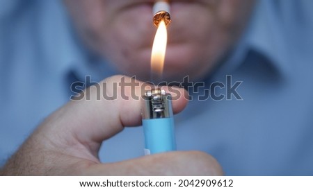 Smoker Lighting a Cigarette with a Gas Lighter. Close Up Shooting with a Person Smoking a Cigarette.