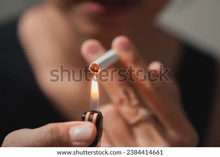 Smoker lighting a cigarette with lighter
