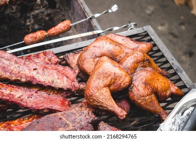 smoker with meat at street food festival.