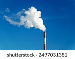 Smokestack emits thick smoke from a pipe, contrasting against a clear blue sky