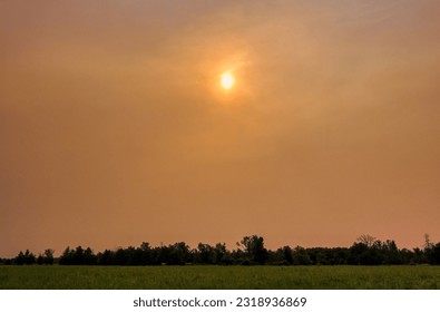 Smokey and Hazy Skies from Wild Fires over a Rural Field