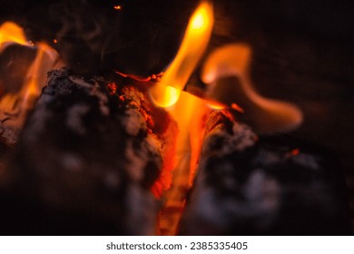 A smokey orange and red abstract flame in a fire pit