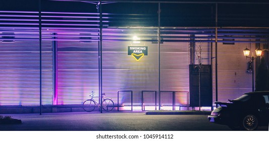 Smoking Area In Front Of A Bar Or Night Club In The Night