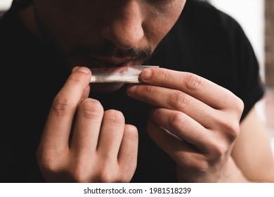 Smoking Cannabis Cbd Concept - Young Man Rolling Marijuana Spliff - Main Focus On Left Hand Holding Joint