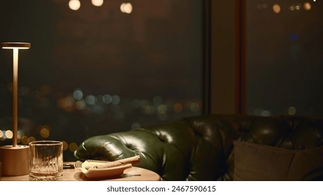 Smoking cigar on table in restaurant. Media. Close-up of smoking cigar with empty glass in a restaurant. Cigar and glass of scotch in luxurious night restaurant - Powered by Shutterstock