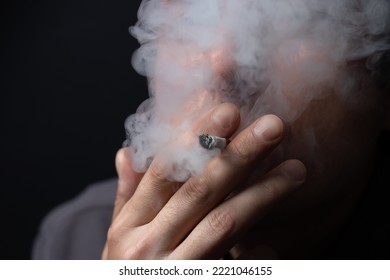 Smoking cigarette in the hand of young man close up. - Powered by Shutterstock