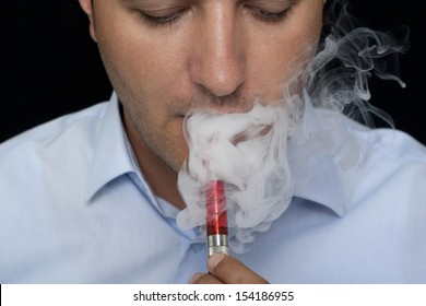 smoking electric cigarettes on the black background