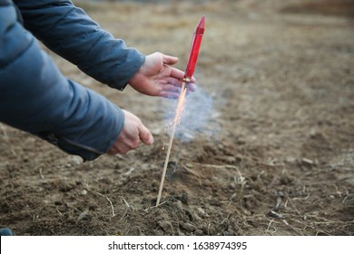 Smoking Firework Rocket On The Ground