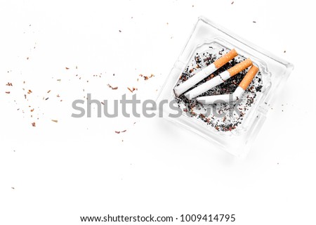 Smoking. Half-smoked cigarettes in ashtray on white background top view copy space