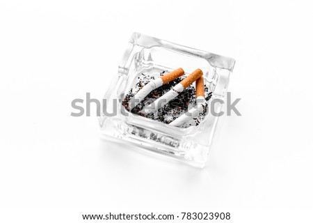 Smoking. Half-smoked cigarettes in ashtray on white background copyspace