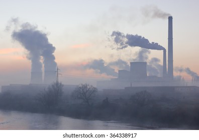 Smoking industrial chimneys at dawn. Concept for environmental protection