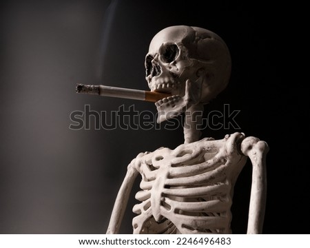 Smoking kills. Human skeleton smoking a cigarette.