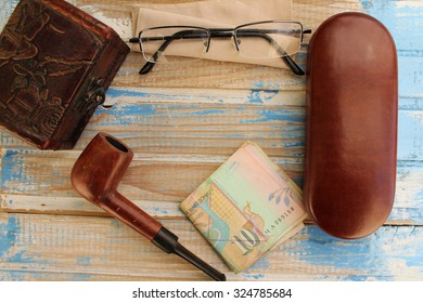 Smoking pipe, eyeglasses case, eyeglasses, money and box - copy space