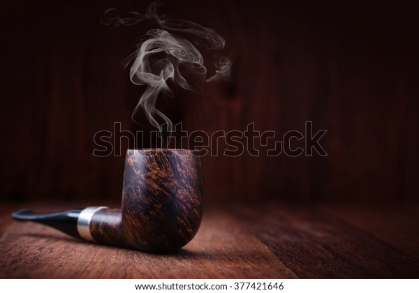Smoking pipe on a wooden\
table