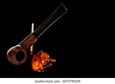 A Smoking Pipe, A Safety Match And Old Amber Man’s Cufflinks On A Black Background In Horizontal Orientation